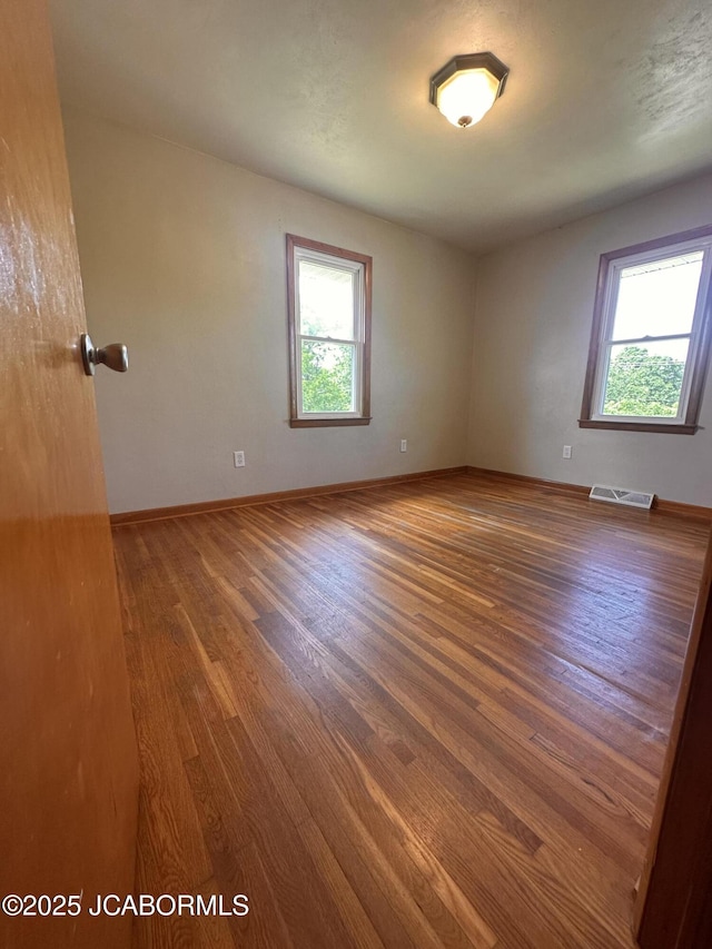 713 Lincoln St, Linn, MO 65051 - unfurnished room featuring healthy amount of natural light, wood finished floors, and baseboards