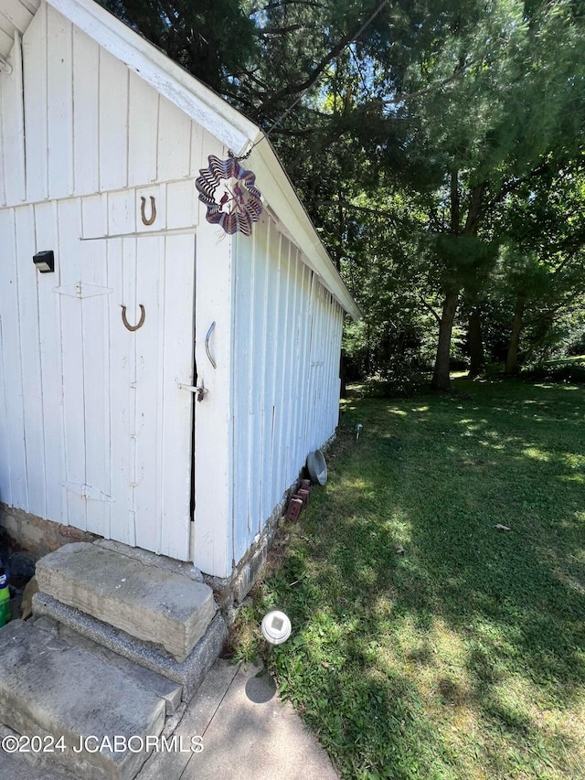 view of outbuilding featuring a lawn