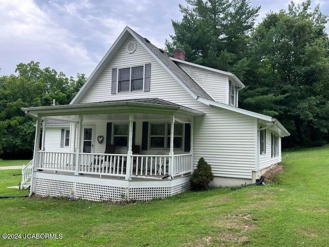 farmhouse-style home with a porch and a front lawn