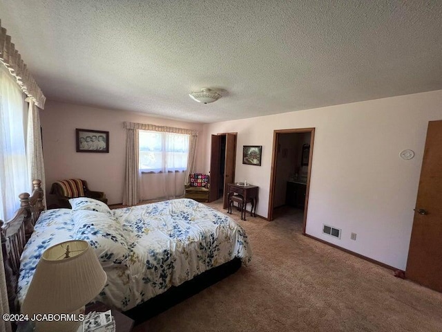 carpeted bedroom featuring a textured ceiling