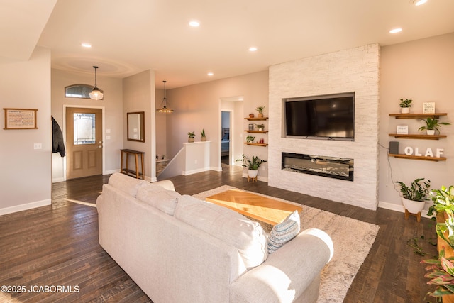 living area featuring a fireplace, wood finished floors, and recessed lighting