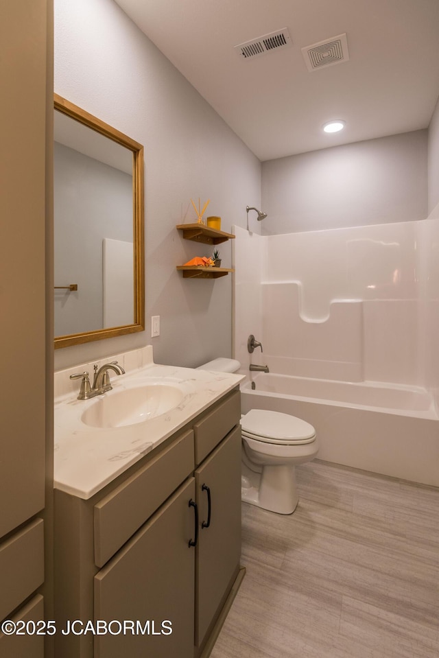 bathroom featuring shower / bath combination, visible vents, vanity, and toilet