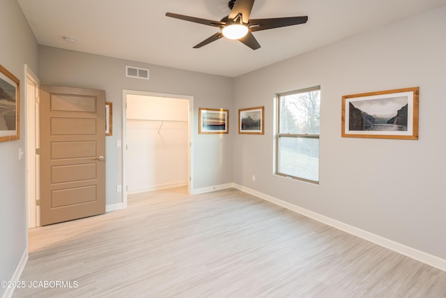 unfurnished bedroom featuring light wood-style flooring, visible vents, and baseboards