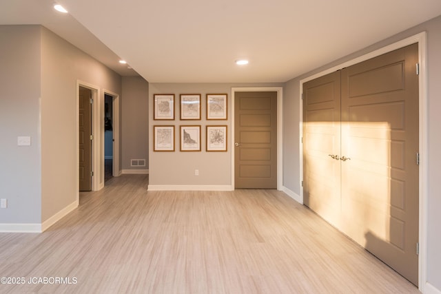 interior space featuring light wood finished floors, recessed lighting, visible vents, and baseboards