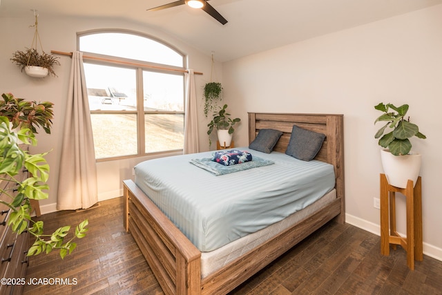 bedroom with vaulted ceiling, dark wood finished floors, a ceiling fan, and baseboards