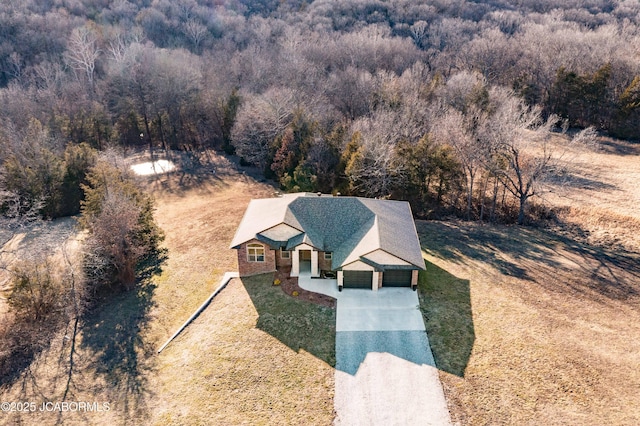 drone / aerial view featuring a view of trees