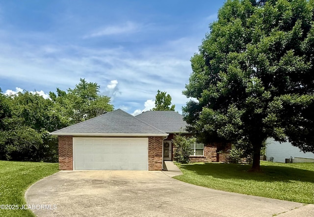 2911 Lake Town Dr, Columbia, MO 65203 - view of front of home with driveway, a front lawn, a garage, and brick siding
