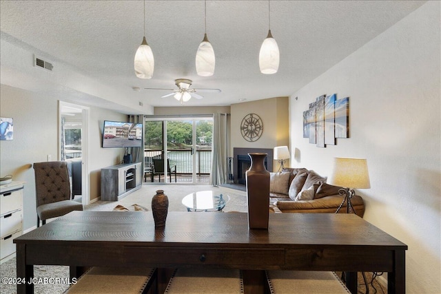 dining space featuring a textured ceiling and ceiling fan