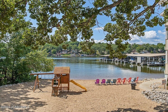 exterior space featuring a playground and a water view