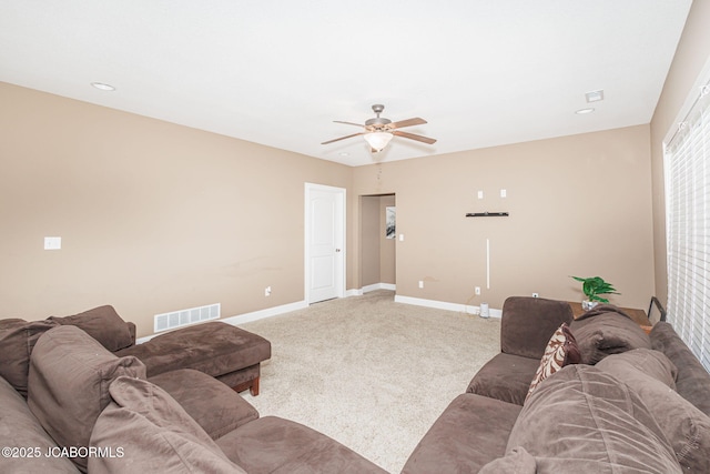 living area with a ceiling fan, baseboards, and carpet floors