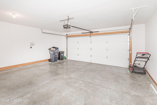 garage with a garage door opener and baseboards