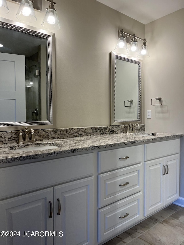 bathroom featuring tile patterned flooring, vanity, and an enclosed shower