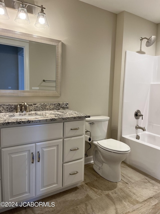 full bathroom with washtub / shower combination, vanity, and toilet