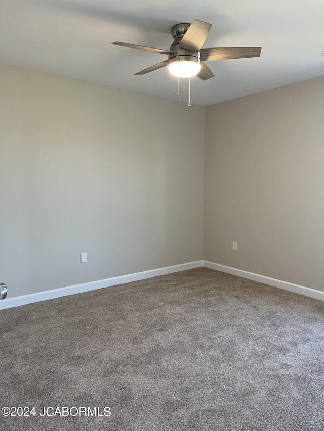 carpeted spare room with ceiling fan