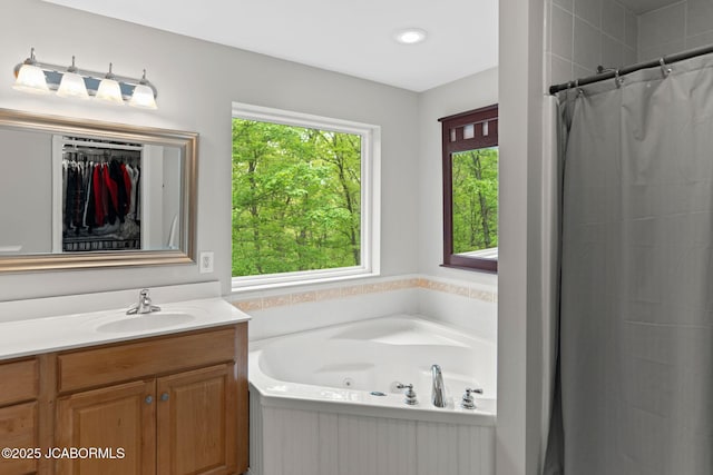 bathroom with vanity, recessed lighting, a shower with curtain, a spacious closet, and a bath