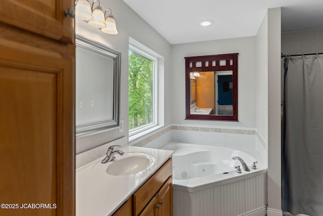 bathroom with a jetted tub and vanity