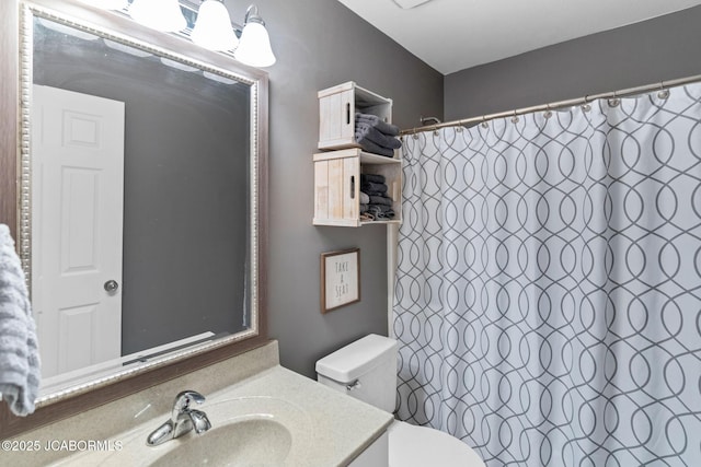 bathroom with toilet, curtained shower, and vanity
