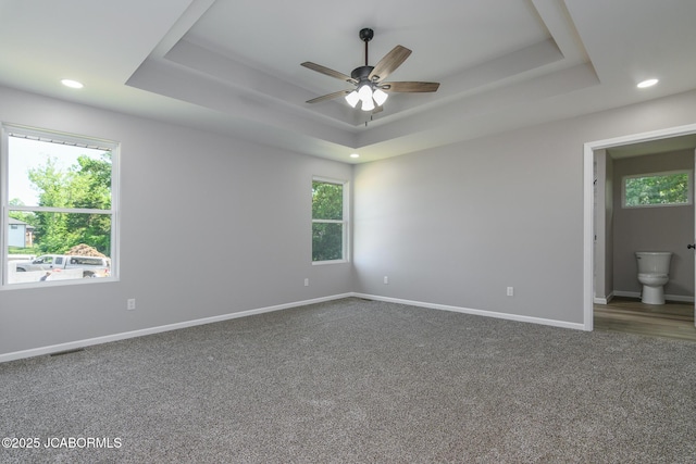 1502 Summerfield Dr, Jefferson City, MO 65109 - carpeted spare room featuring a raised ceiling, ceiling fan, baseboards, and recessed lighting