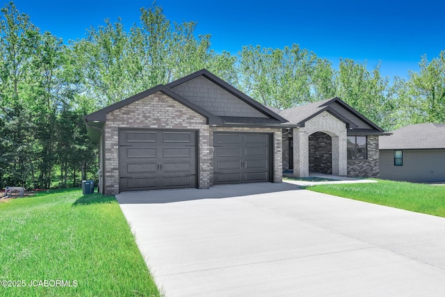 1502 Summerfield Dr, Jefferson City, MO 65109 - view of front facade with driveway, a garage, a front lawn, brick siding, and cooling unit
