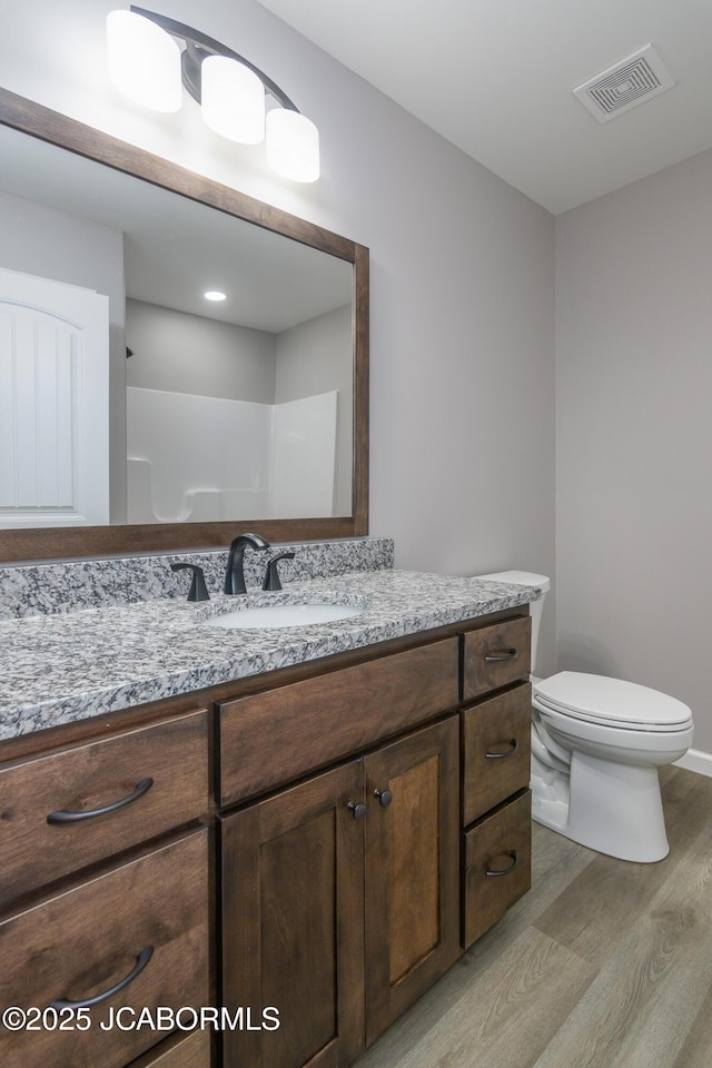 1502 Summerfield Dr, Jefferson City, MO 65109 - bathroom featuring wood finished floors, vanity, toilet, and baseboards