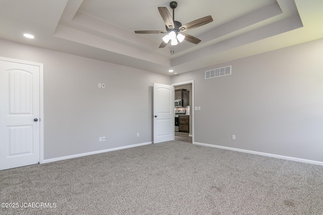 1502 Summerfield Dr, Jefferson City, MO 65109 - unfurnished bedroom featuring a raised ceiling, carpet, baseboards, and recessed lighting