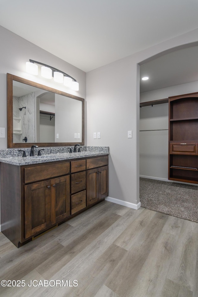 1502 Summerfield Dr, Jefferson City, MO 65109 - full bath featuring wood finished floors, double vanity, and baseboards