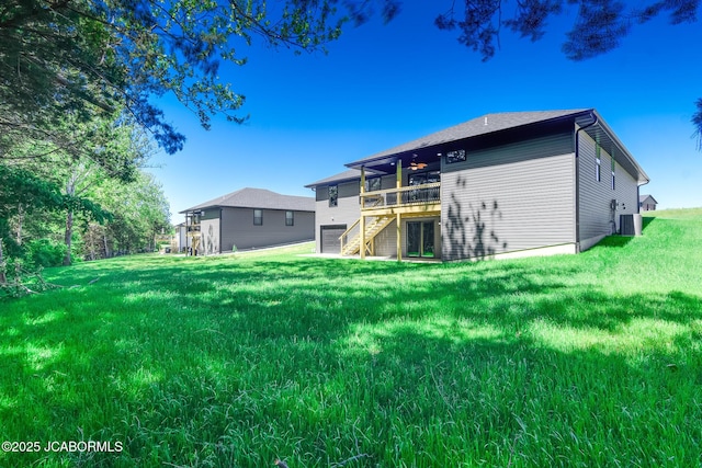 1502 Summerfield Dr, Jefferson City, MO 65109 - back of property featuring a wooden deck, stairway, an attached garage, and a yard