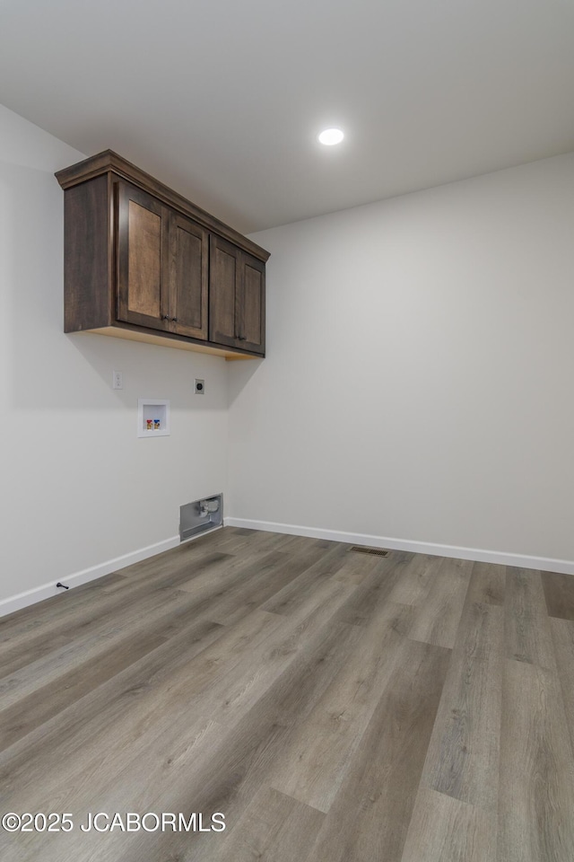 1502 Summerfield Dr, Jefferson City, MO 65109 - washroom with hookup for an electric dryer, hookup for a washing machine, wood finished floors, baseboards, and recessed lighting
