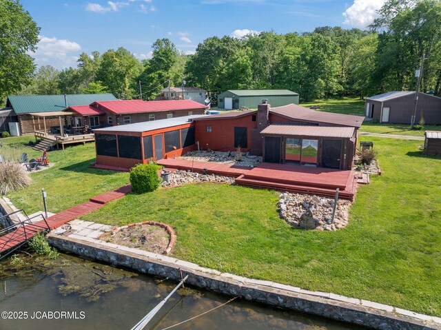 24671 Gardner Rd, Versailles, MO 65084 - back of house featuring a sunroom, a deck with water view, a yard, and a chimney