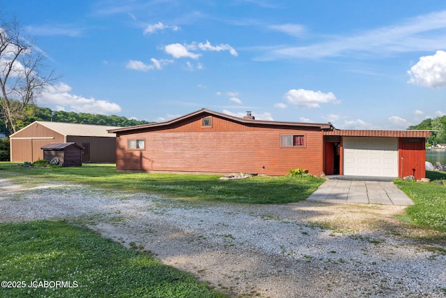 24671 Gardner Rd, Versailles, MO 65084 - view of side of home with driveway and an attached garage