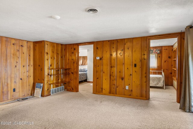 24671 Gardner Rd, Versailles, MO 65084 - carpeted spare room with wooden walls and a textured ceiling