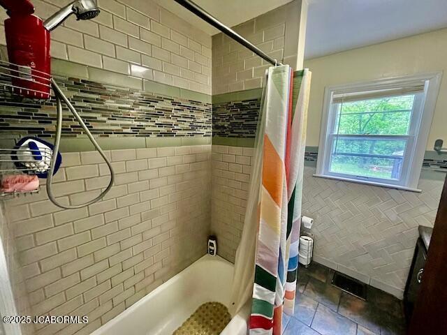 711 Cardinal St, Jefferson City, MO 65101 - full bathroom with shower / bath combo with shower curtain and tile walls
