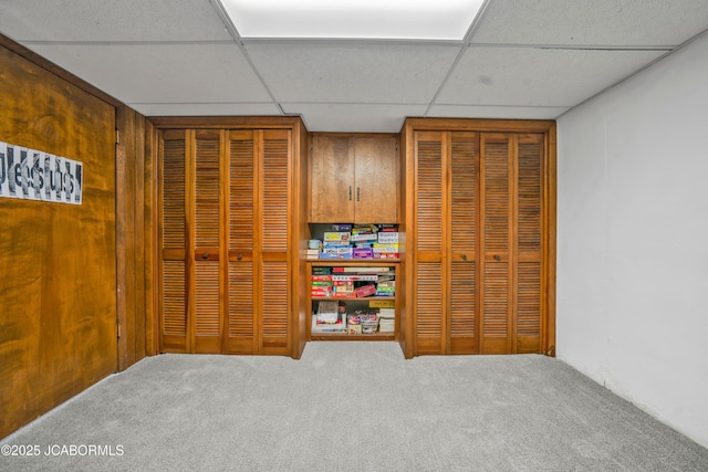 interior space with a drop ceiling and carpet