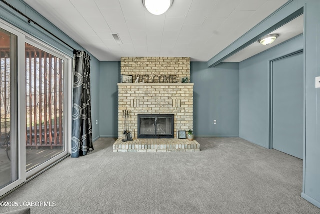 unfurnished living room with a brick fireplace, visible vents, and carpet floors