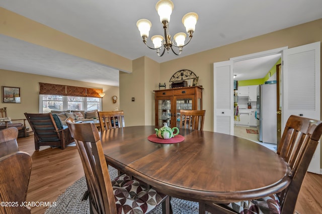 dining room featuring a notable chandelier and wood finished floors