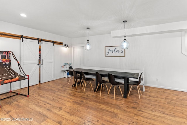 109 Redtail Dr, Ashland, MO 65010 - dining area with a barn door and wood finished floors