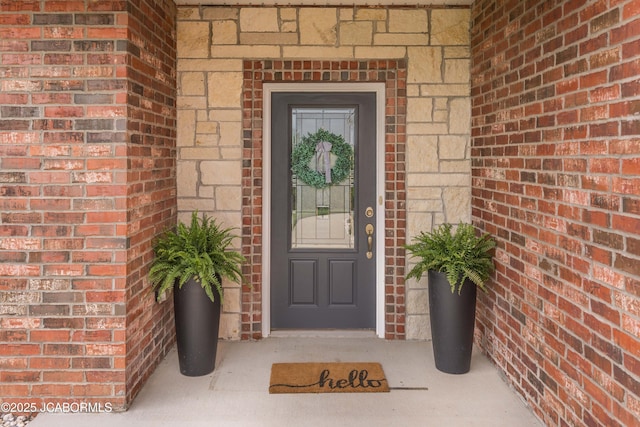 property entrance featuring brick siding