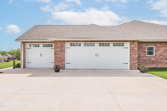 view of front of property featuring brick siding, driveway, a shingled roof, and a garage