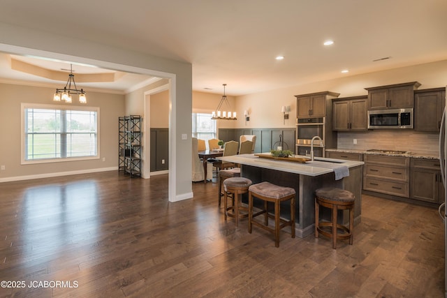 kitchen featuring stainless steel appliances, a sink, an inviting chandelier, and recessed lighting