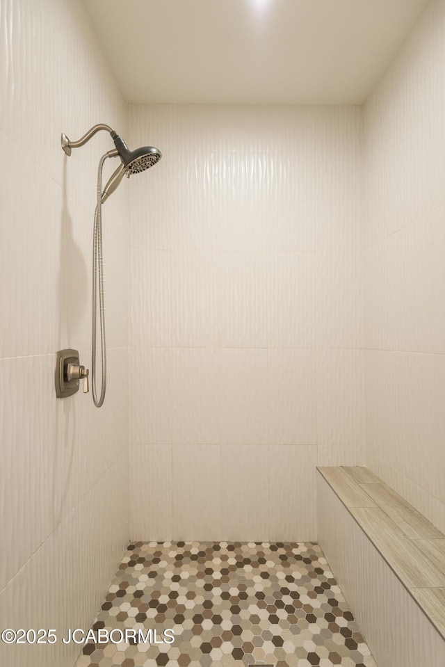 bathroom with a tile shower