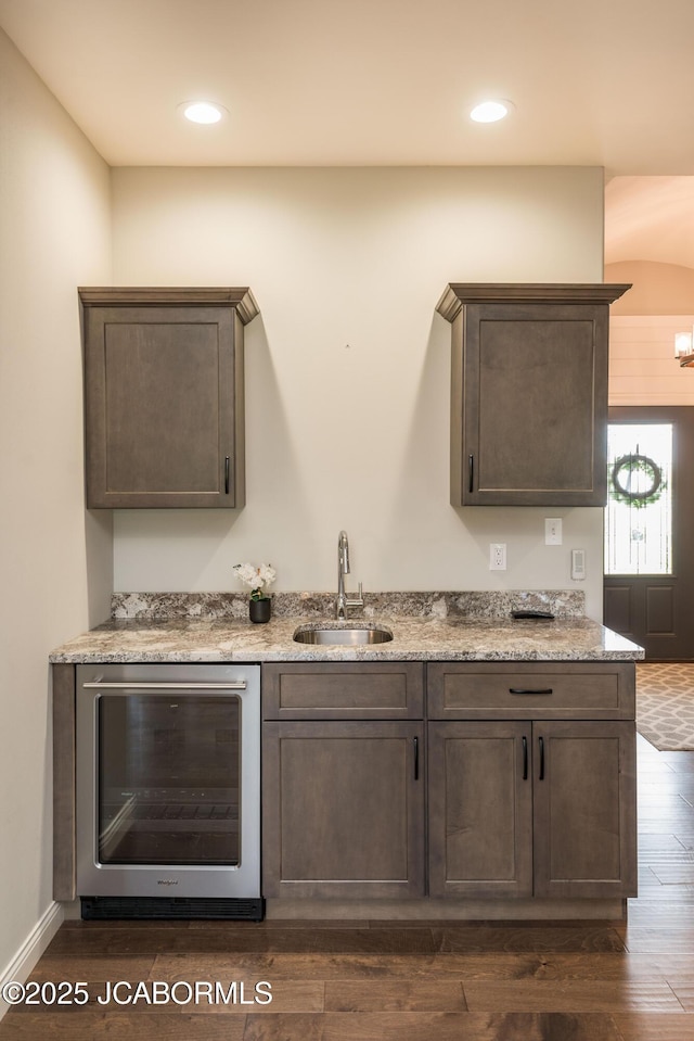 bar with recessed lighting, dark wood-style floors, wine cooler, and a sink