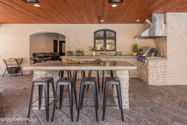 view of patio with outdoor wet bar, an outdoor kitchen, and area for grilling