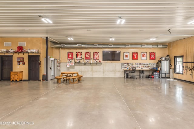 garage featuring a workshop area and visible vents