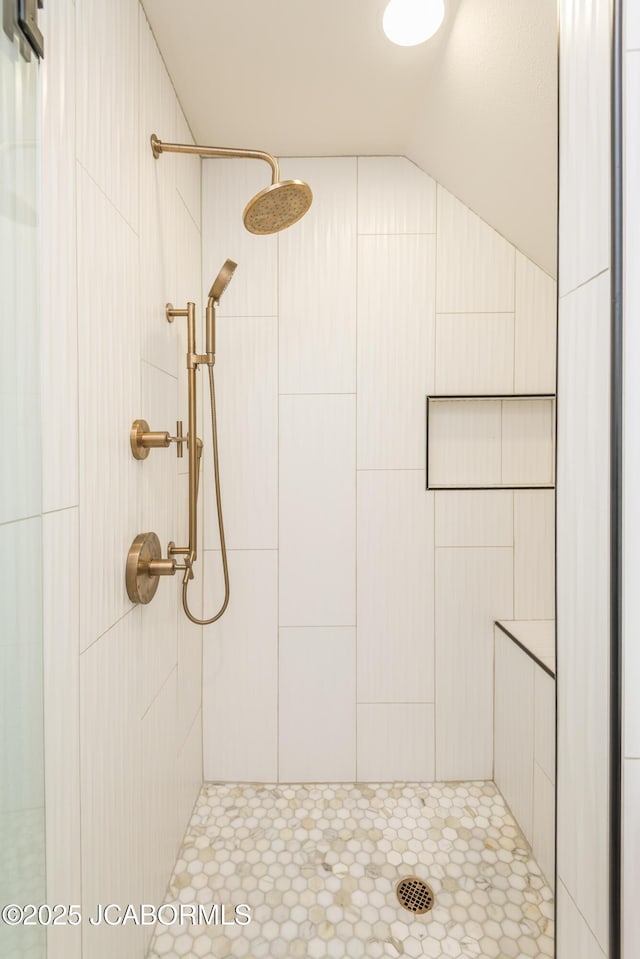 bathroom with a tile shower