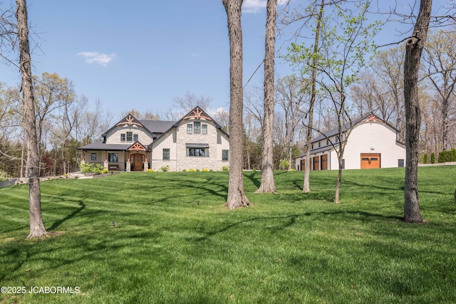 view of front of house with a front lawn and a detached garage