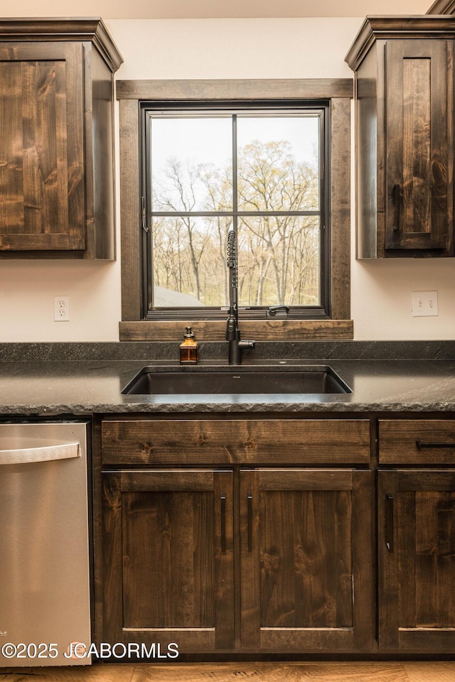 kitchen with stainless steel dishwasher, dark brown cabinetry, and a sink