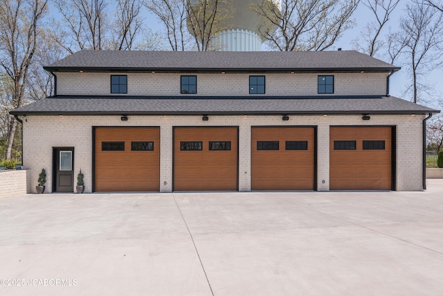 garage featuring concrete driveway