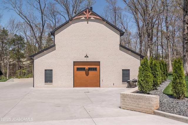 exterior space with a garage and concrete driveway