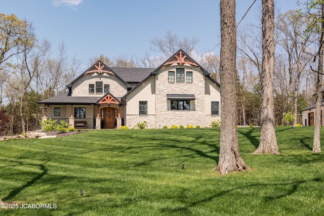 view of front of house with a porch, stone siding, and a front yard