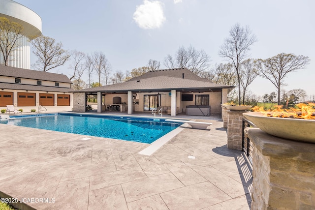 pool with a ceiling fan, a hot tub, a patio, and a diving board